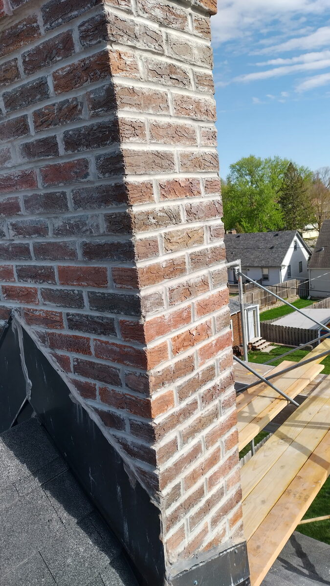 Corner detail of rebuilt Omaha chimney with crisp fresh mortar joints