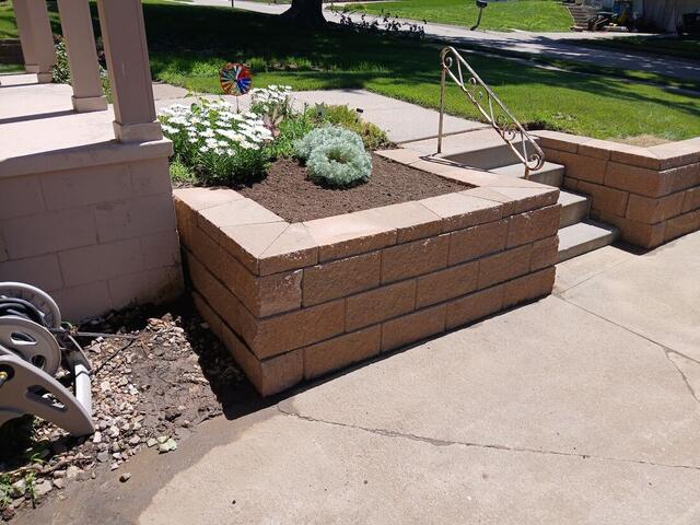 Block masonry planter boxes built beside a front porch