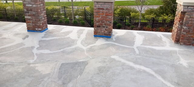 Flagstone-finish concrete patio with brick pillars in Omaha